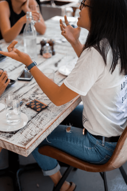 Lady explaining her point using her hands to emphasize